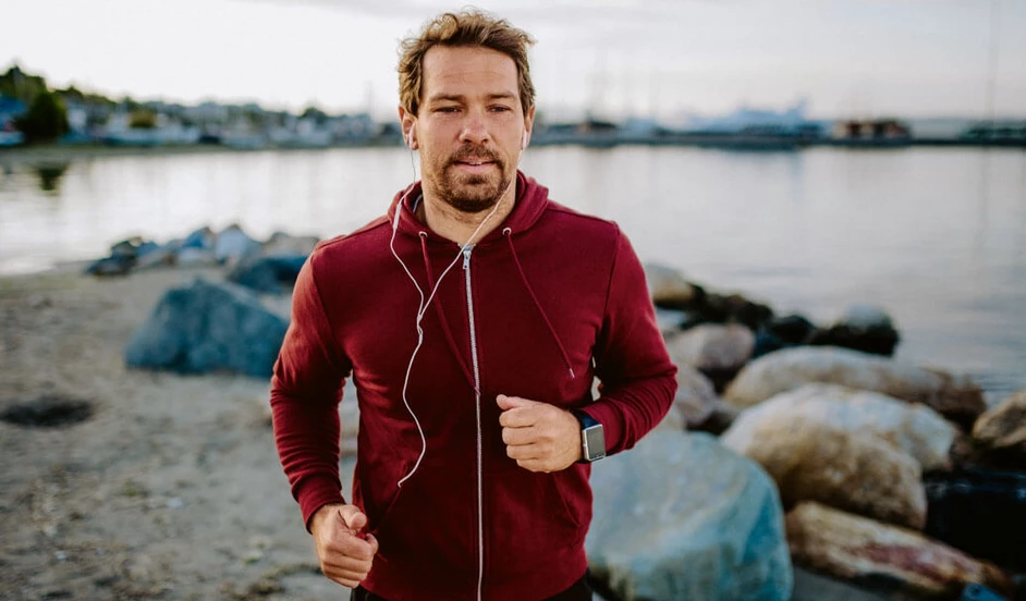 Sportlicher Mann jogggt am Strand